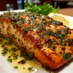 Freshly prepared garlic butter salmon on white plate