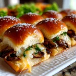 Freshly prepared Mini Mushroom Swiss Sliders on white plate