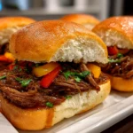 Freshly prepared Slow Cooker Italian Beef Sandwiches served on white plate