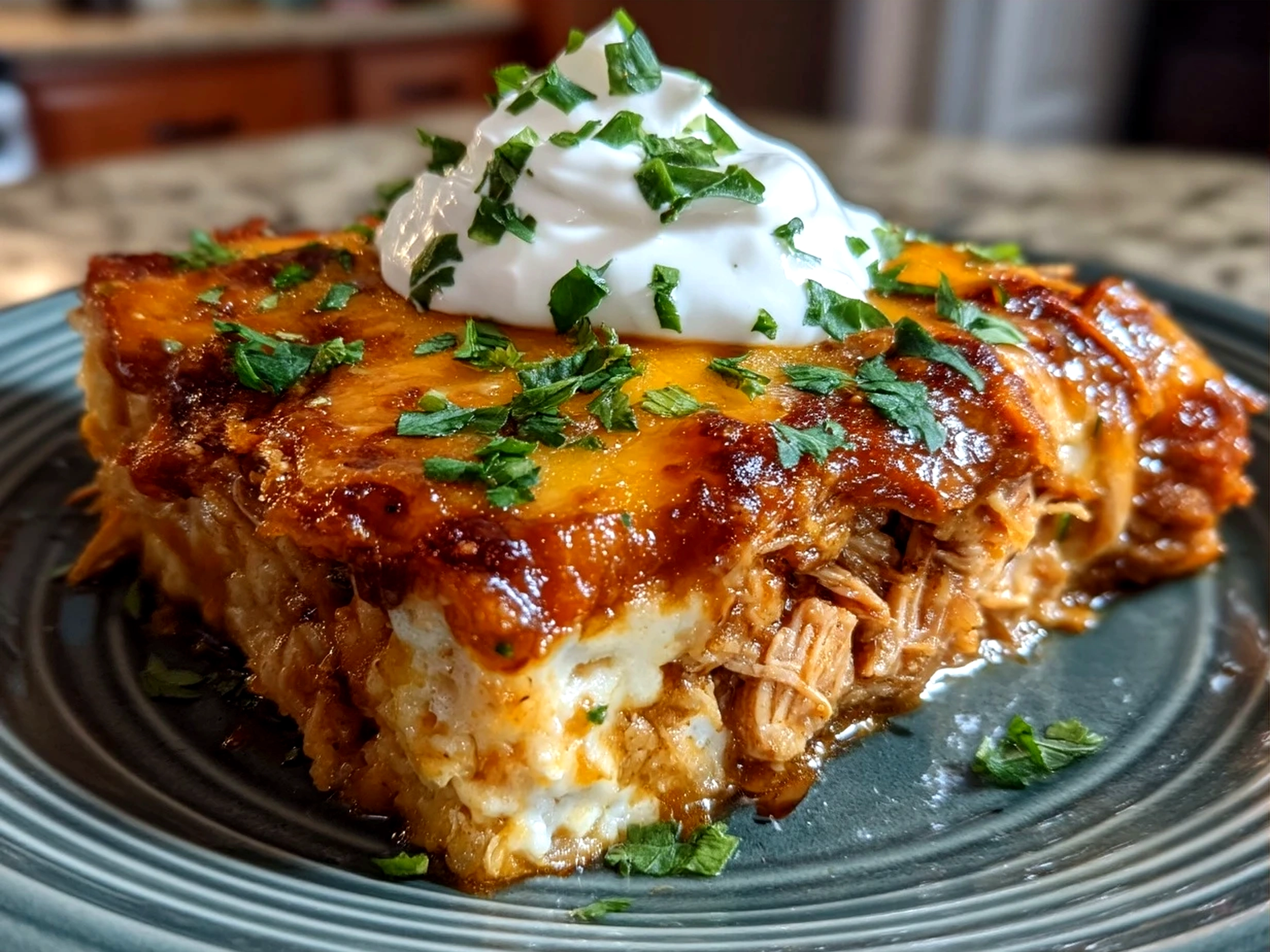Baked Shredded Chicken Enchilada Casserole served with lime and avocado slices on a plate