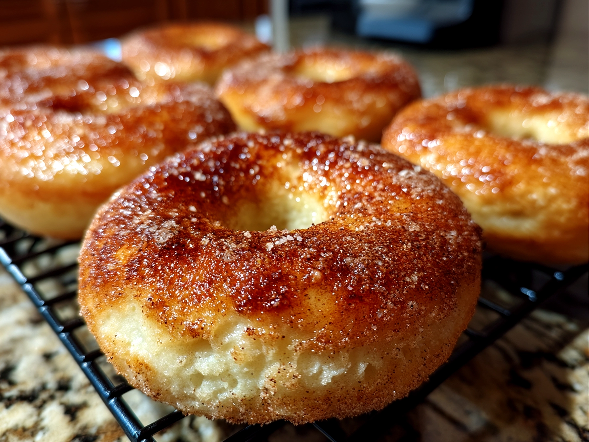 Close-up photo of finished comforting cinnamon sugar bagels with a slightly angled view